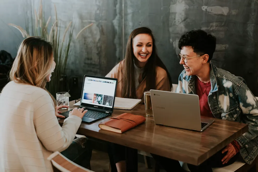 Small team collaborating around a laptop